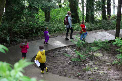 A class of children walking on a trail